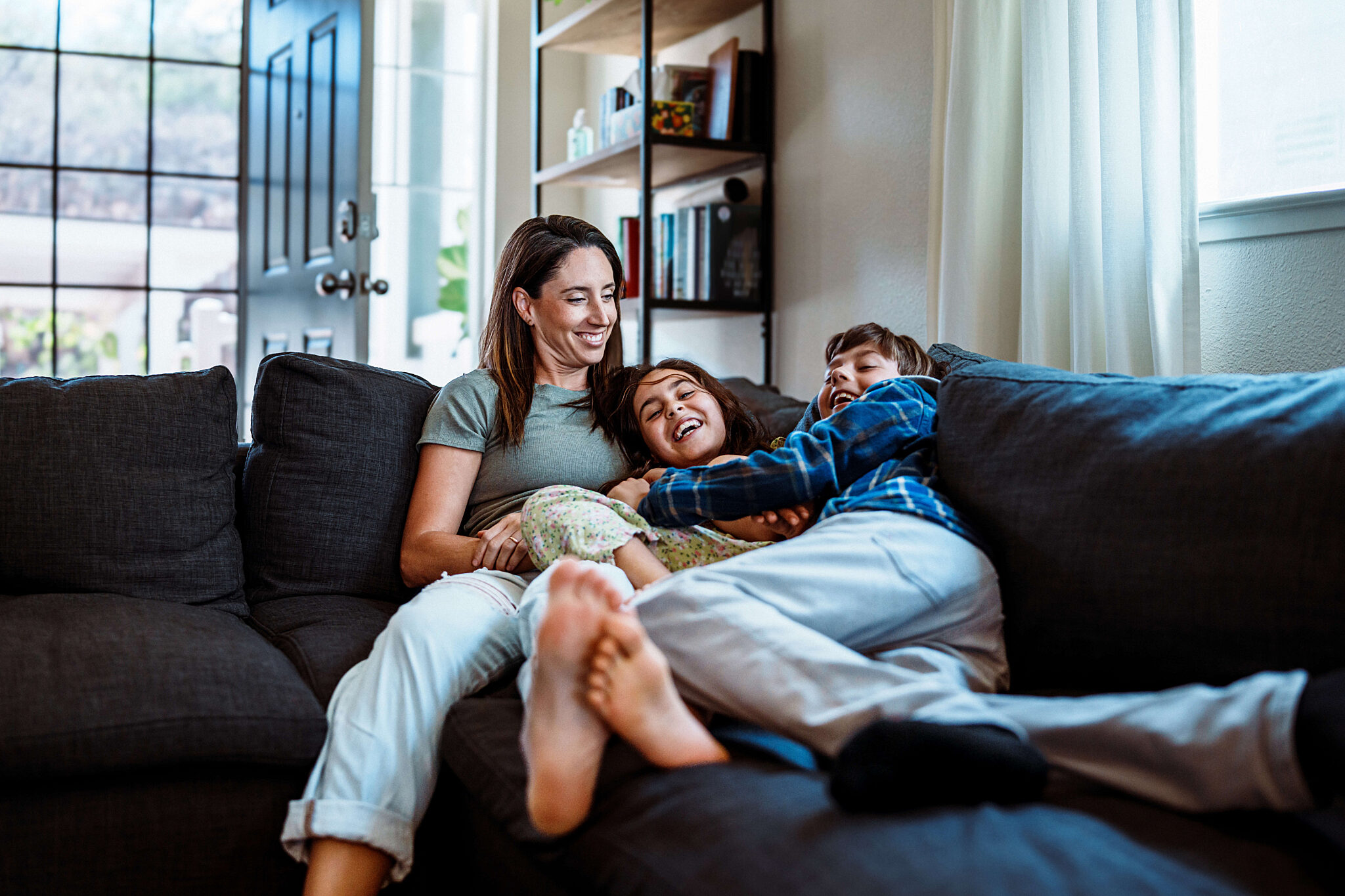 Mother and kids relaxing on couch